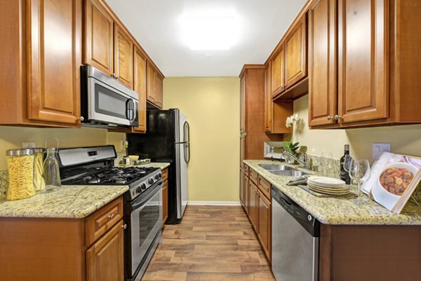 Modern kitchen with stainless steel appliances at Sunbow Villas Apartments