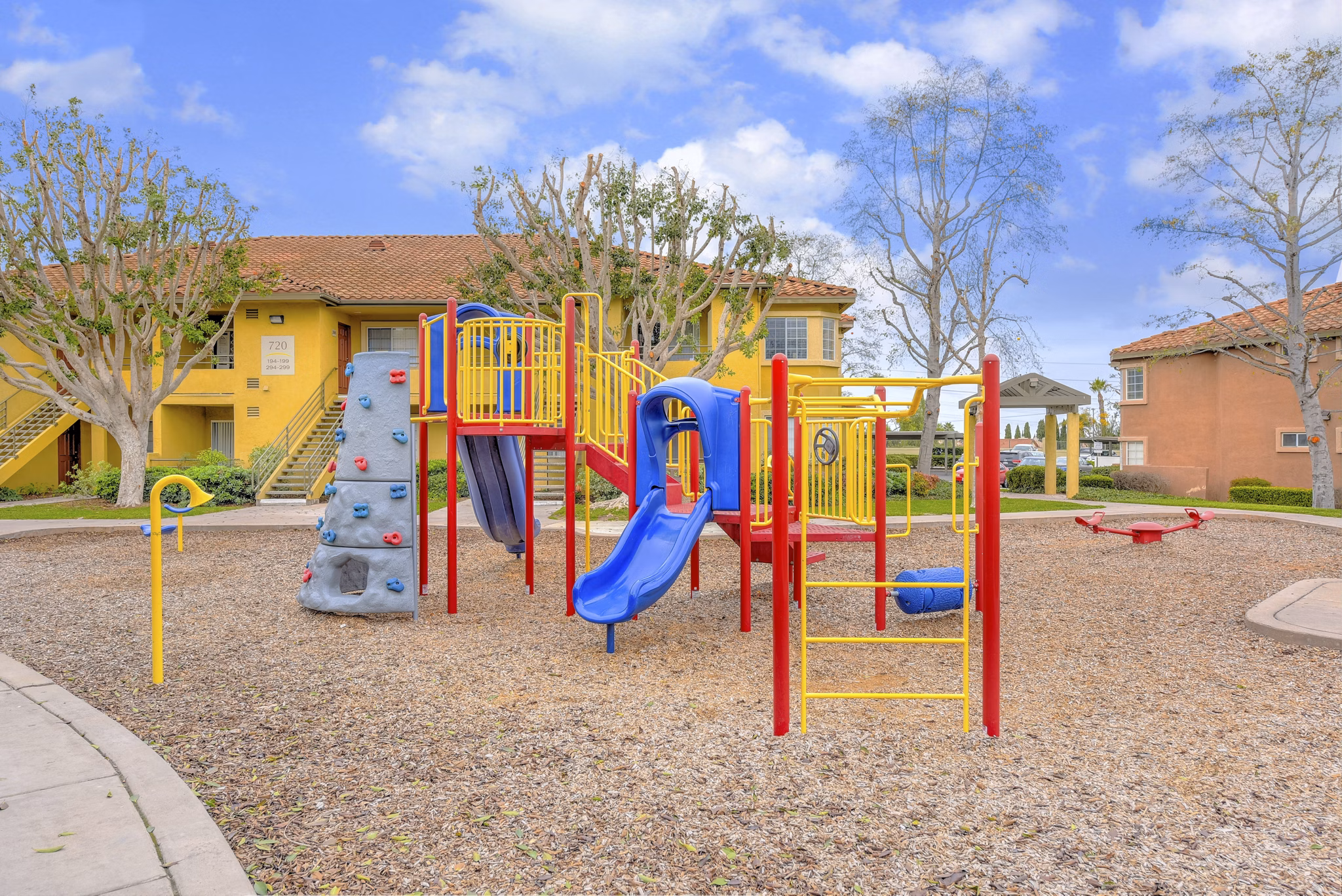 Playground area with modern play structures at Sunbow Villas Apartments, a family-friendly community focused on luxury and comfort