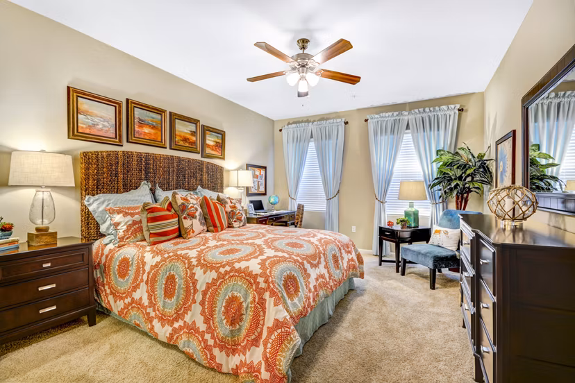 Modern bedroom with elegant decor and ample natural light at Tavera Apartments
