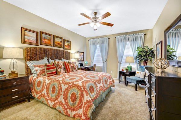 Modern bedroom with elegant decor and ample natural light at Tavera Apartments