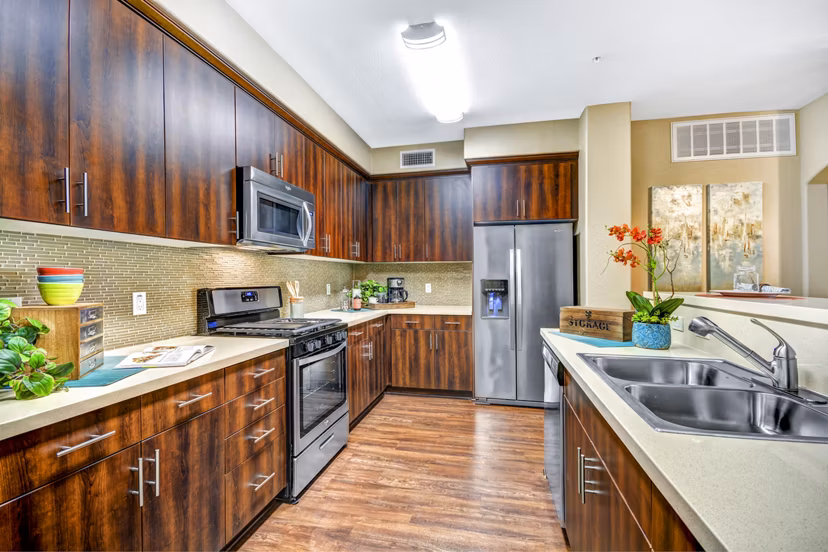 Kitchen featuring modern appliances and sleek countertops at Tavera Apartments