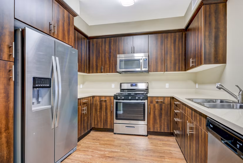 Modern kitchen with sleek cabinetry and stainless steel appliances in Tavera Apartments