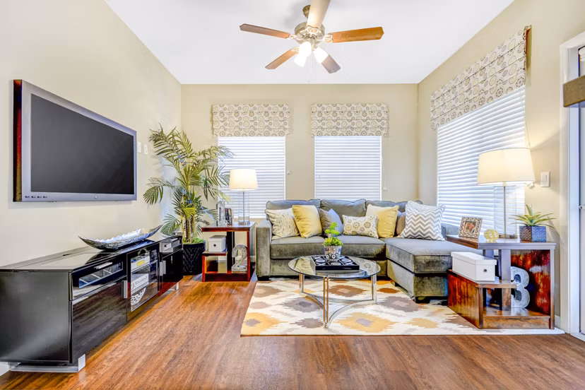 Spacious living room with modern furnishings and large windows in Tavera Apartments Ideal for luxury living