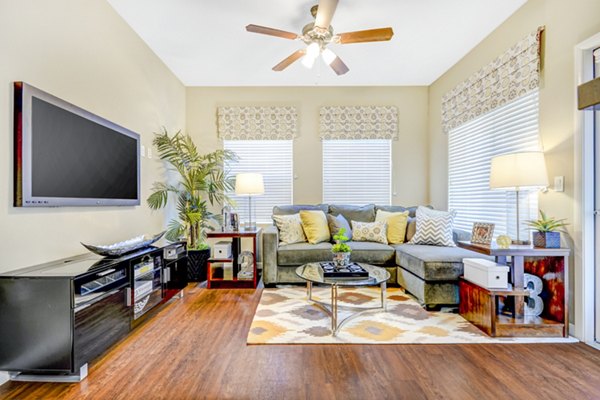 Spacious living room with modern furnishings and large windows in Tavera Apartments Ideal for luxury living