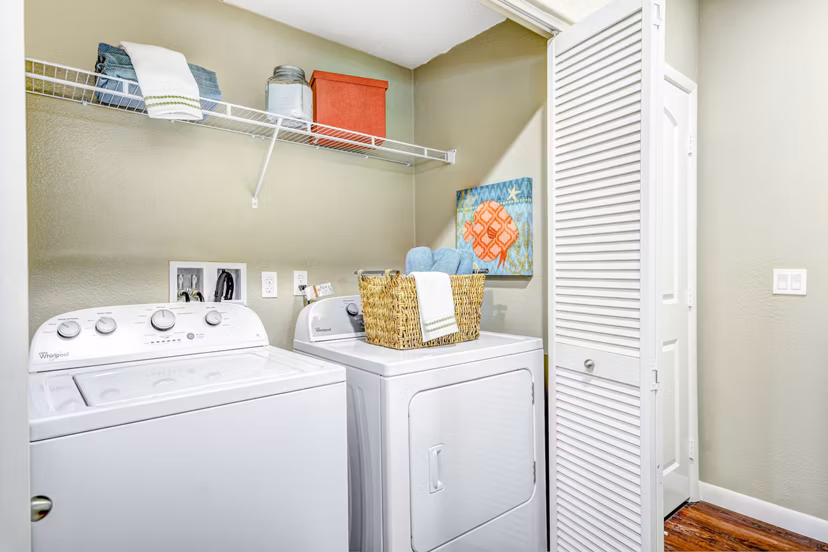 Modern laundry room featuring high-efficiency washers and dryers at Tavera Apartments