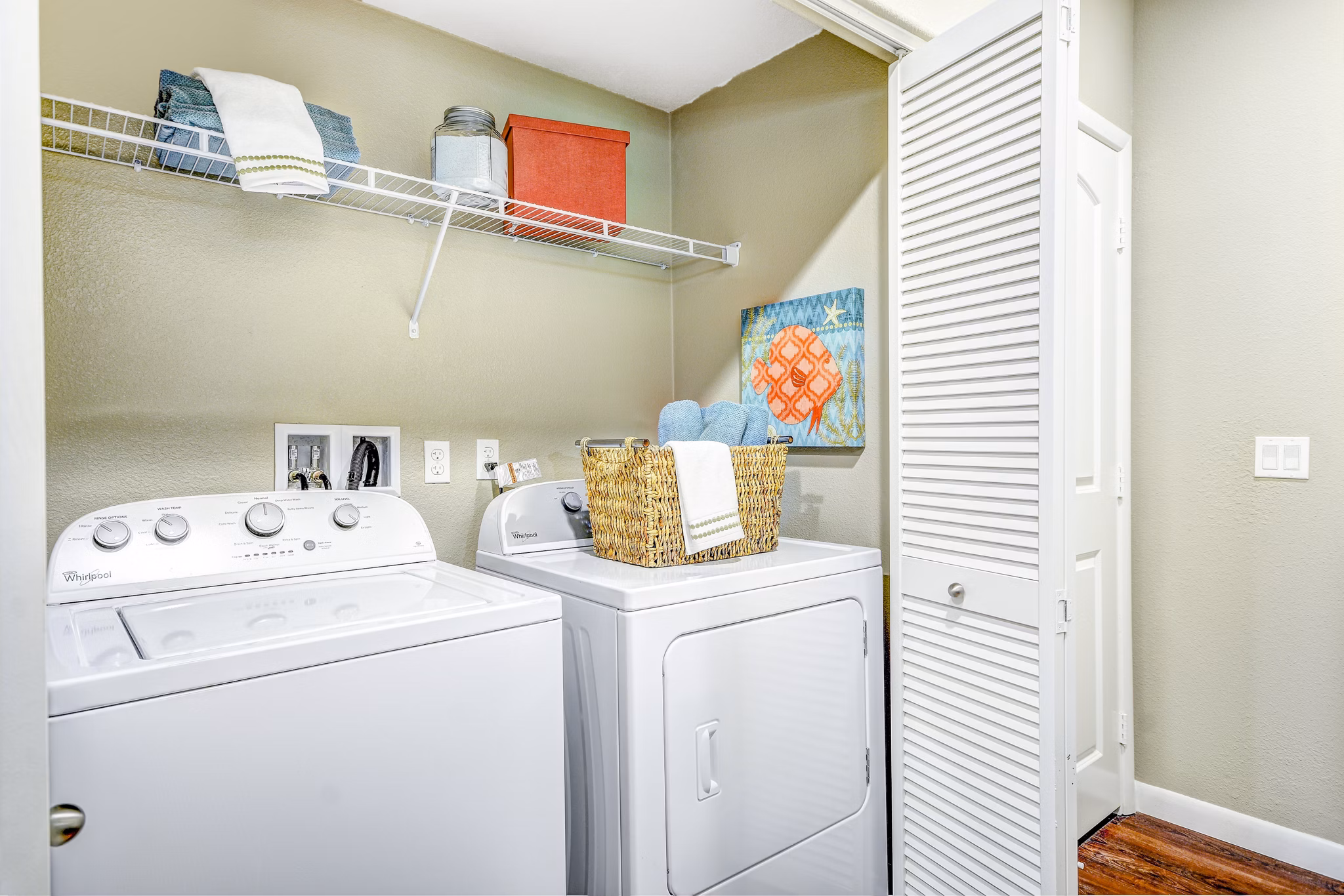 Modern laundry room featuring high-efficiency washers and dryers at Tavera Apartments