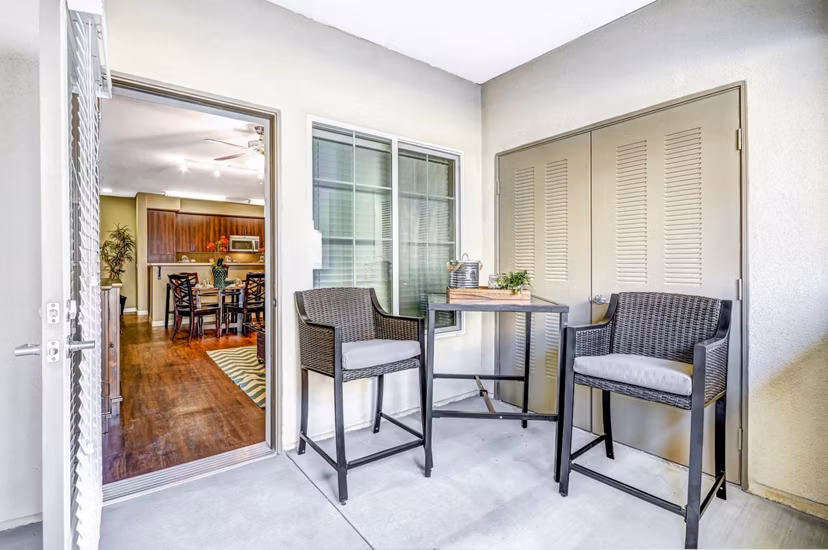Tavera Apartments: Cozy patio balcony with modern furniture in San Diego