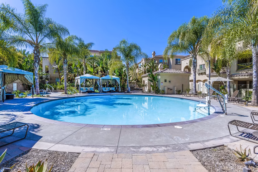 Poolside luxury at Tavera Apartments: Modern outdoor pool area featuring stylish loungers and vibrant landscaping for a relaxing experience