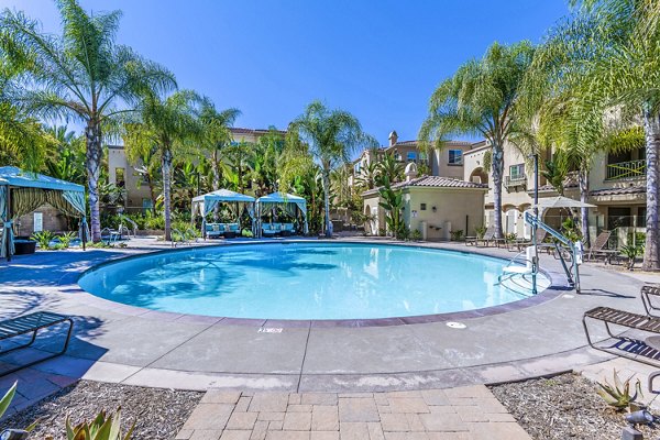Poolside luxury at Tavera Apartments: Modern outdoor pool area featuring stylish loungers and vibrant landscaping for a relaxing experience