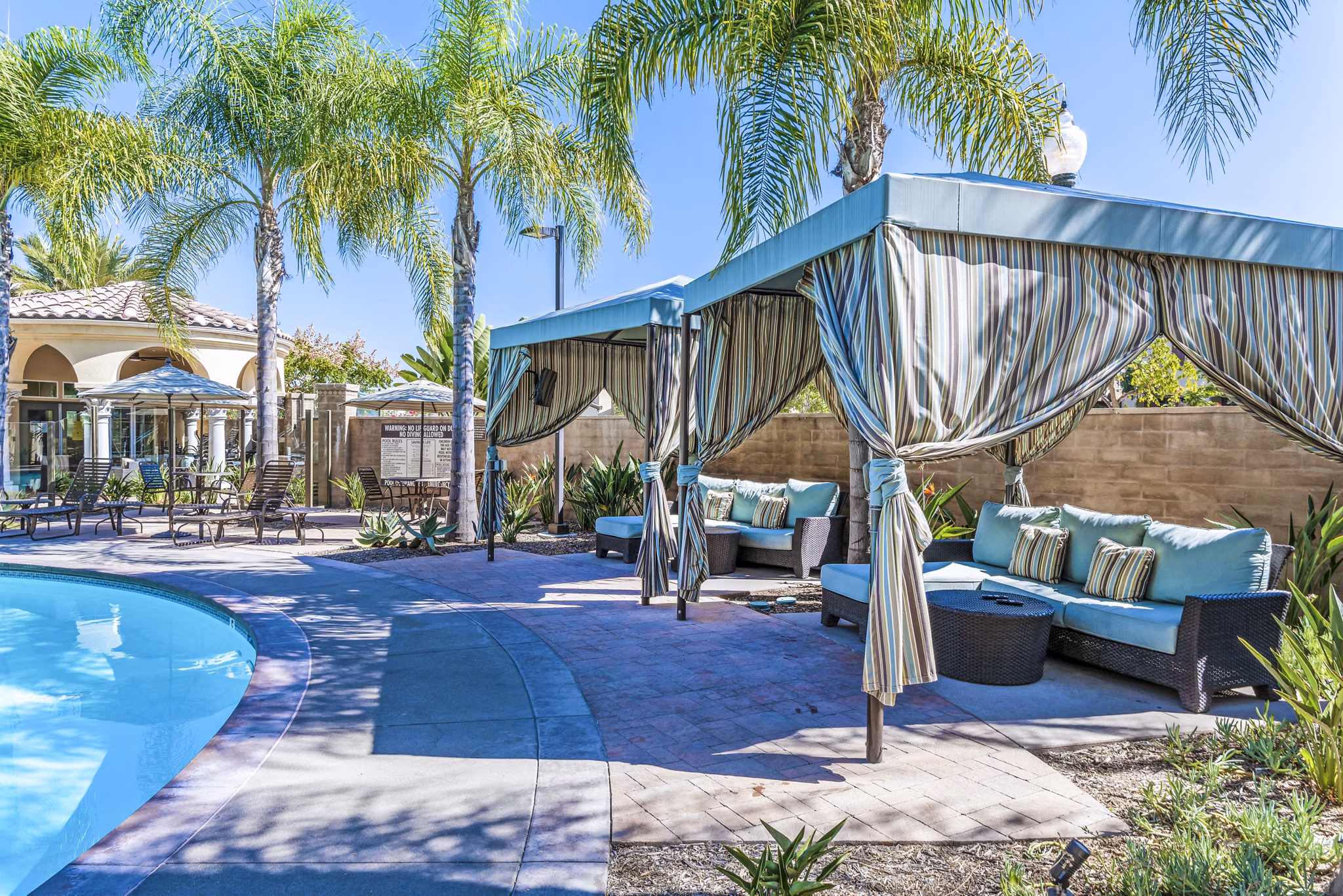 Relaxing pool area surrounded by lush landscaping at Tavera Apartments