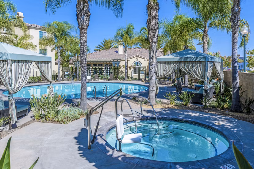 Resort-style pool with lounging areas at Tavera Apartments