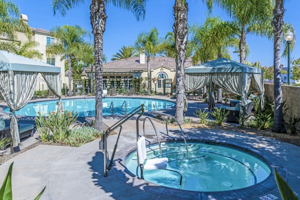 Resort-style pool with lounging areas at Tavera Apartments