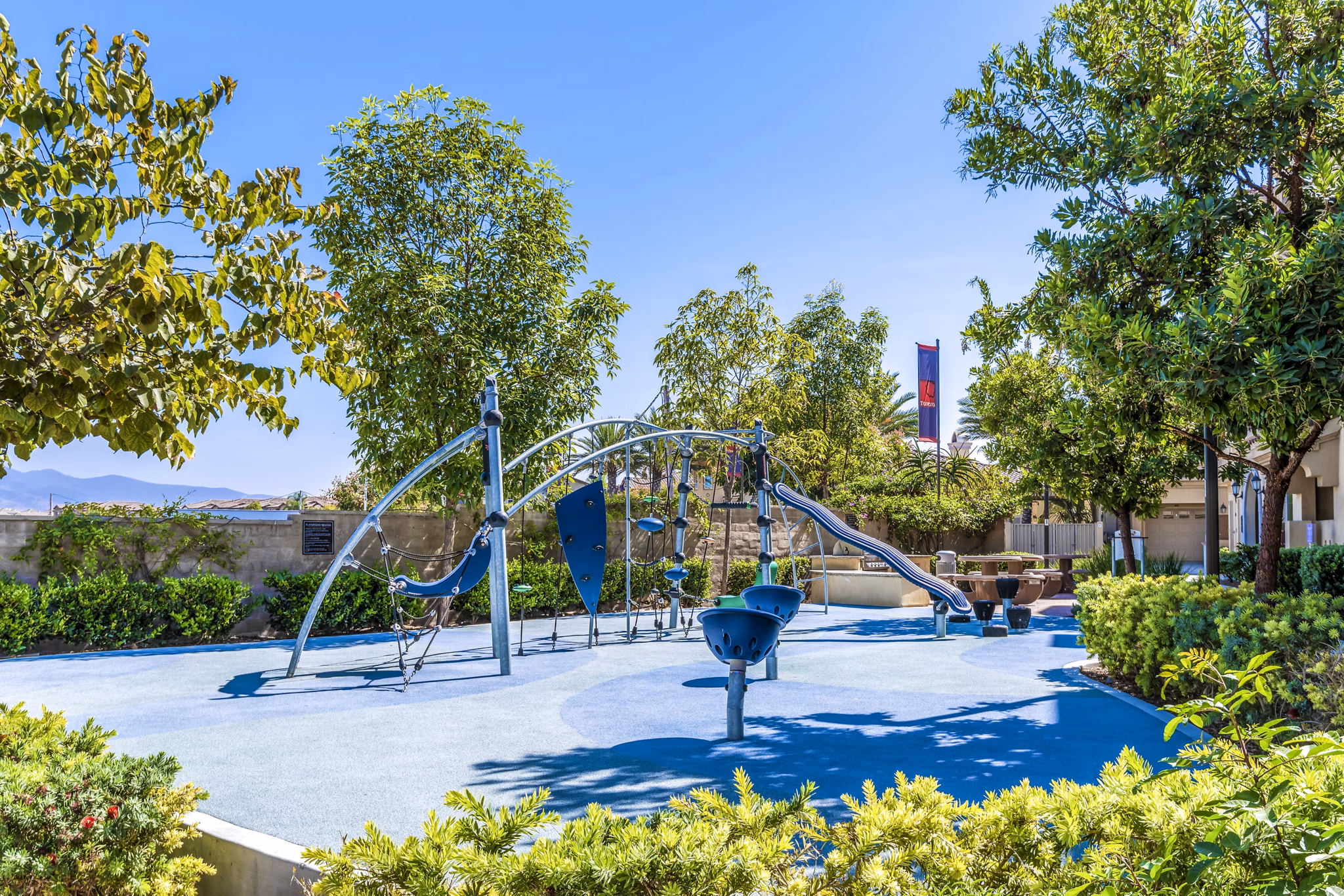 Playground with colorful equipment at Tavera Apartments offering fun outdoor activities for families and children