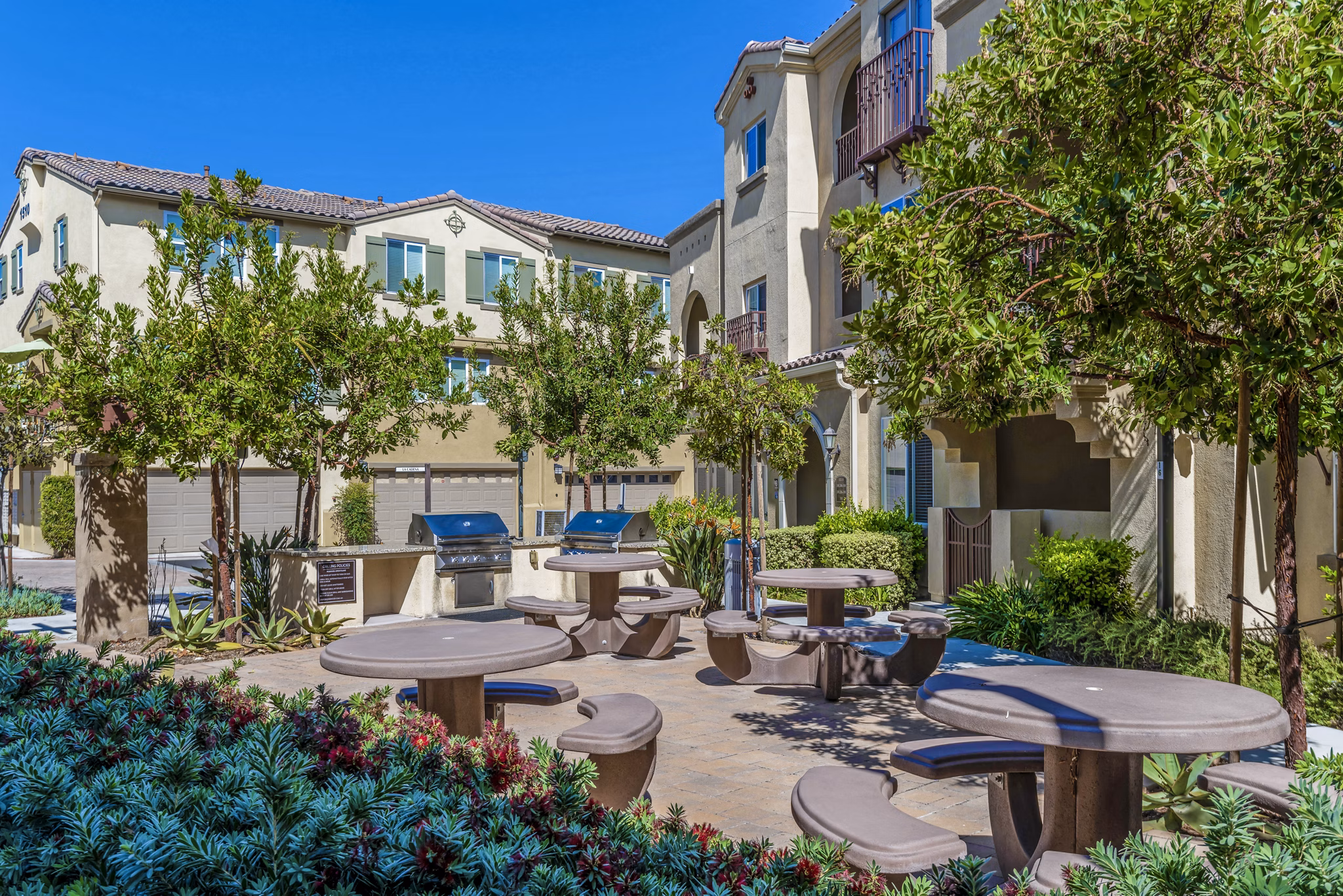 Grill area with modern seating at Tavera Apartments' luxury community courtyard