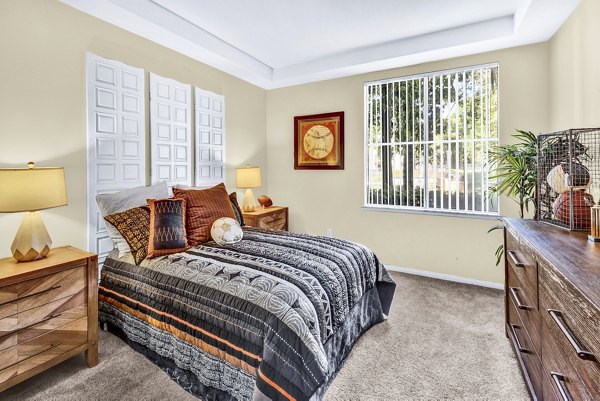 Cozy bedroom with modern furnishings at Terra Vista Apartments, ideal for comfort and relaxation in luxury living