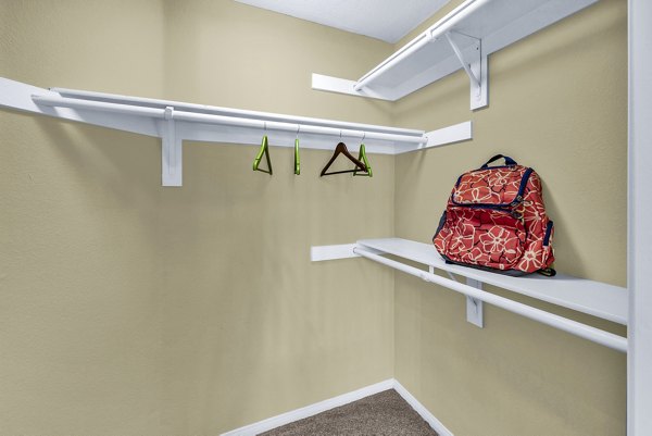 Spacious bedroom closet with modern shelving in Terra Vista Apartments