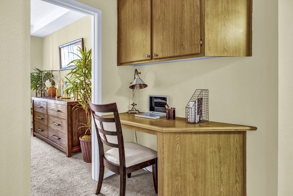 Home office area with modern desk and ergonomic chair at Terra Vista Apartments, ideal for remote work and productivity in a luxury setting