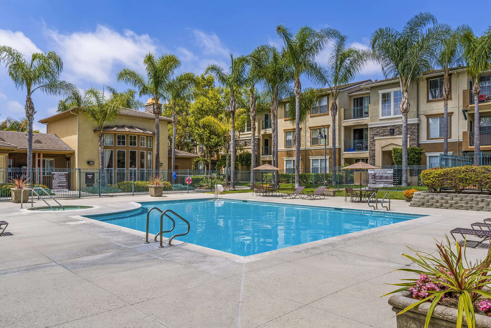 Inviting pool area with lounge chairs at Terra Vista Apartments, offering relaxation and community ambiance for residents