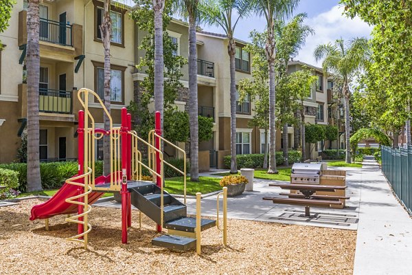 Modern playground with slides and swings at Terra Vista Apartments, designed for children's activities and community enjoyment