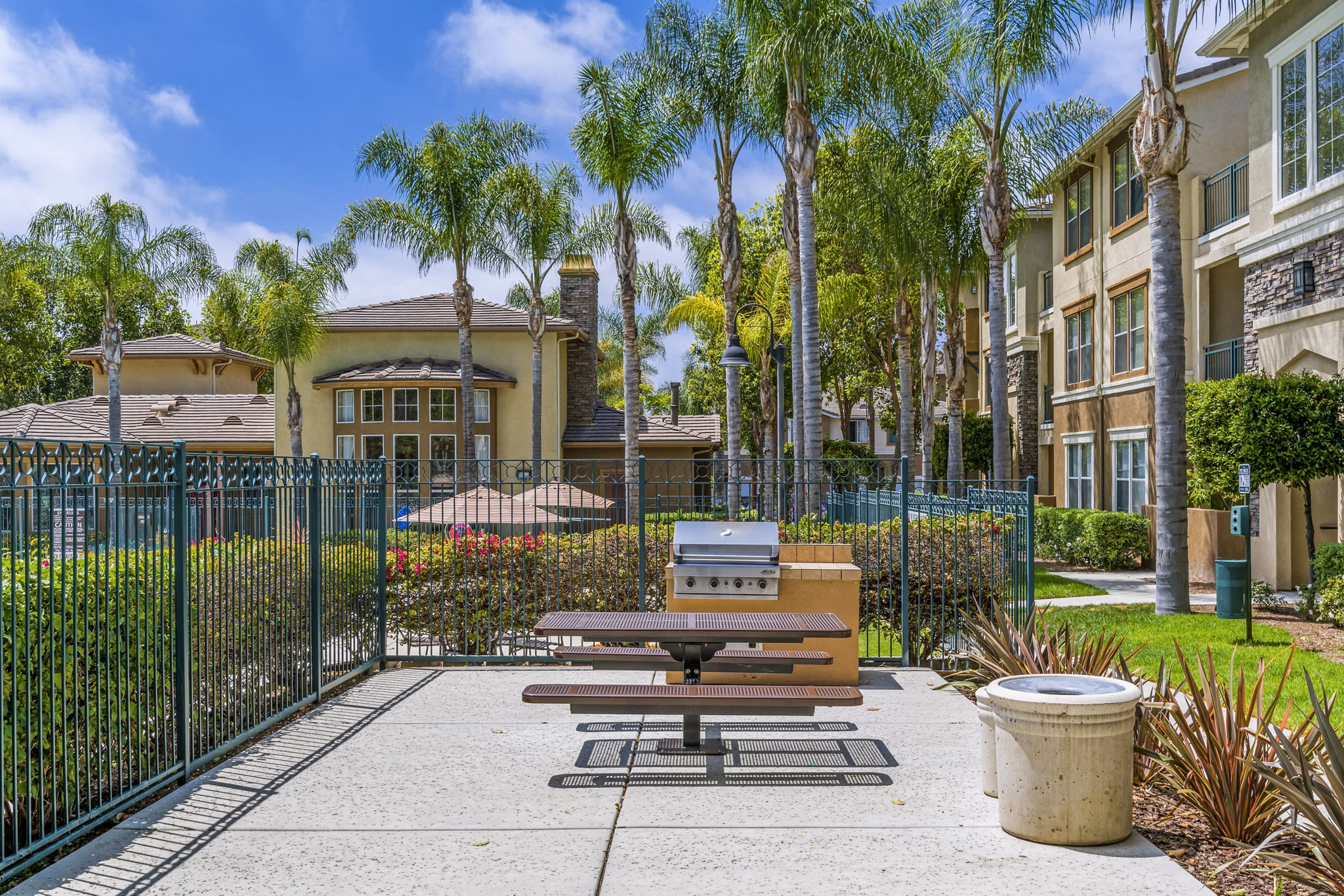 Outdoor grill area with modern seating at Terra Vista Apartments