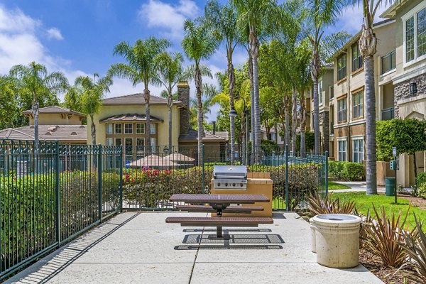 Outdoor grill area with modern seating at Terra Vista Apartments