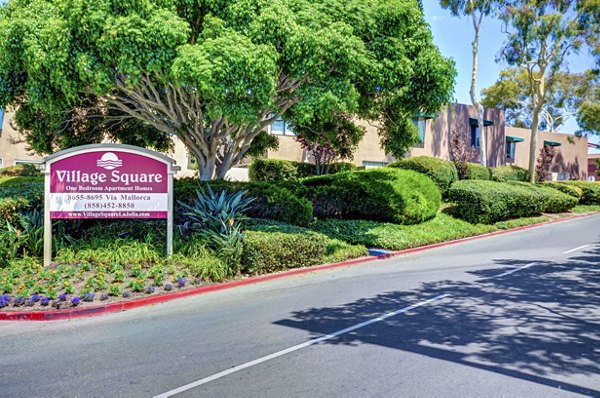 Village Square Apartments: Contemporary facade and landscaped grounds at luxury apartment community