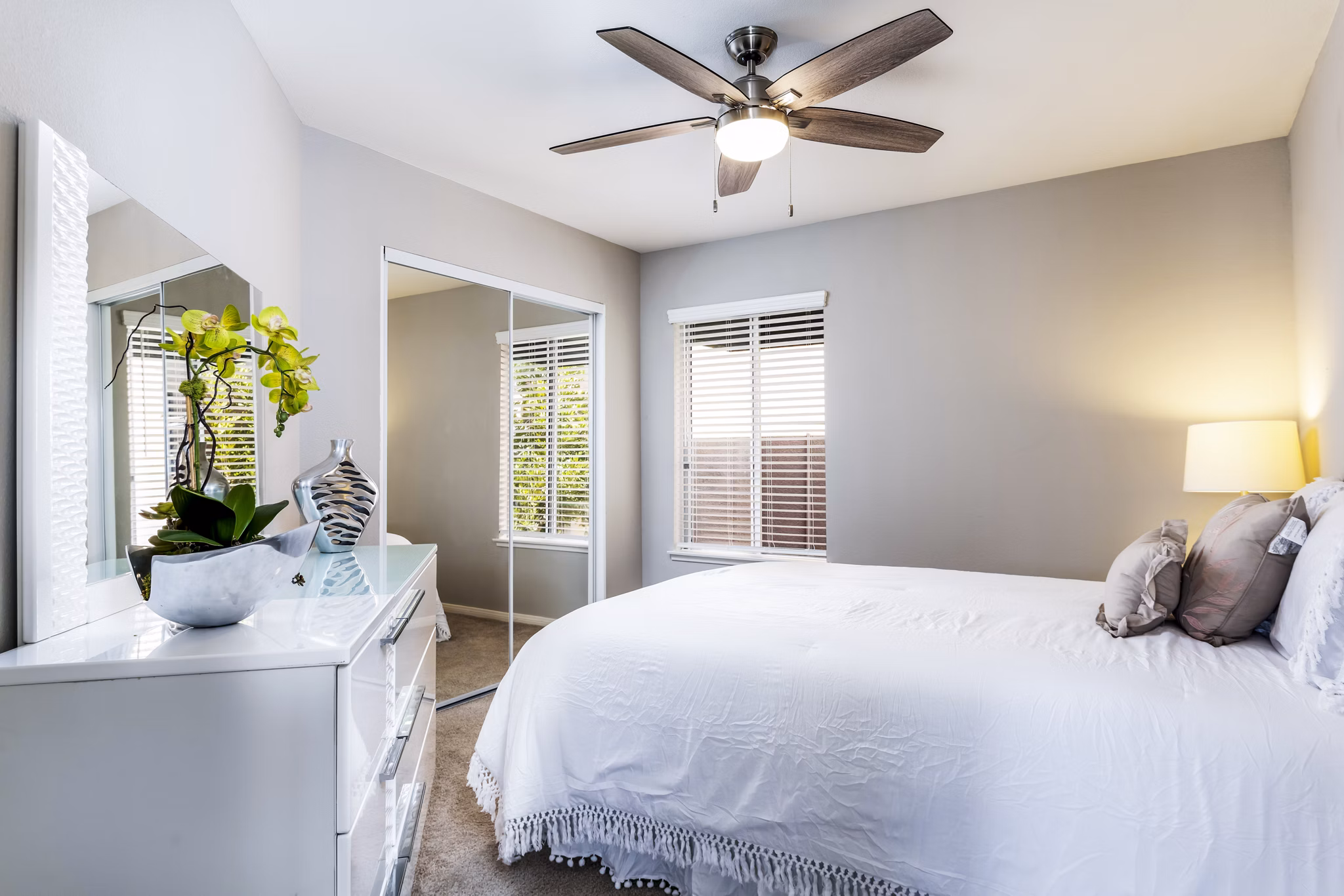 Cozy bedroom with modern furnishings at Village Square Apartments