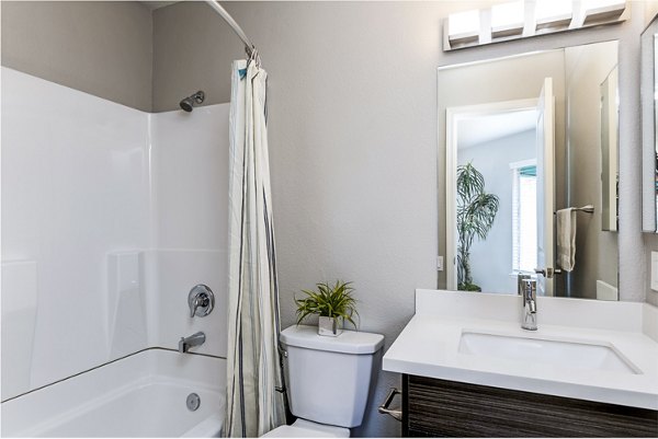 Bathroom featuring elegant fixtures and marble countertops in Village Square Apartments