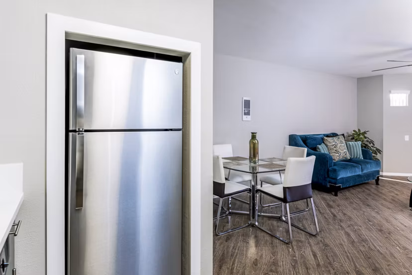 Modern kitchen with stainless steel appliances at Village Square Apartments