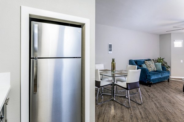 Modern kitchen with stainless steel appliances at Village Square Apartments