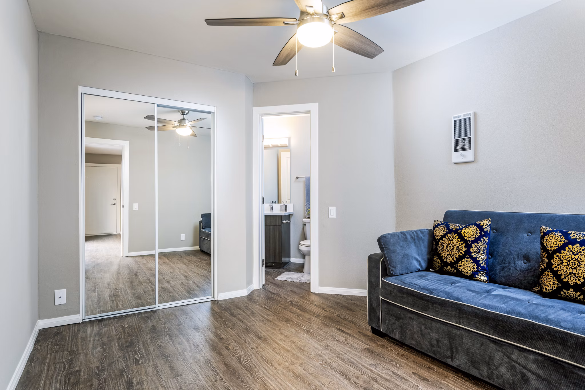 Spacious living room with contemporary decor at Village Square Apartments, offering a luxurious ambiance in the heart of the community