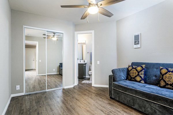Spacious living room with contemporary decor at Village Square Apartments, offering a luxurious ambiance in the heart of the community