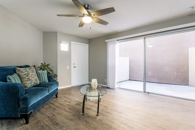Inviting living room with modern decor and ample natural light in Village Square Apartments