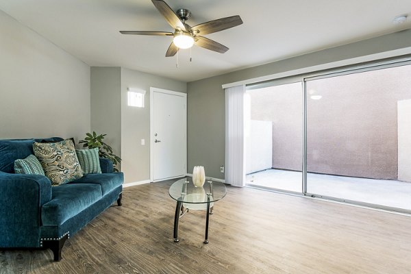 Inviting living room with modern decor and ample natural light in Village Square Apartments