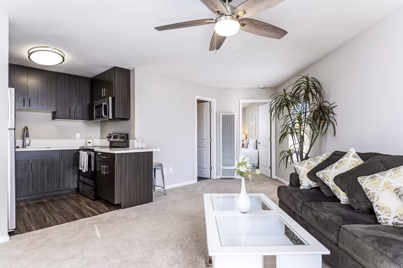Spacious living room with modern decor at Village Square Apartments, offering luxury living in a premier location