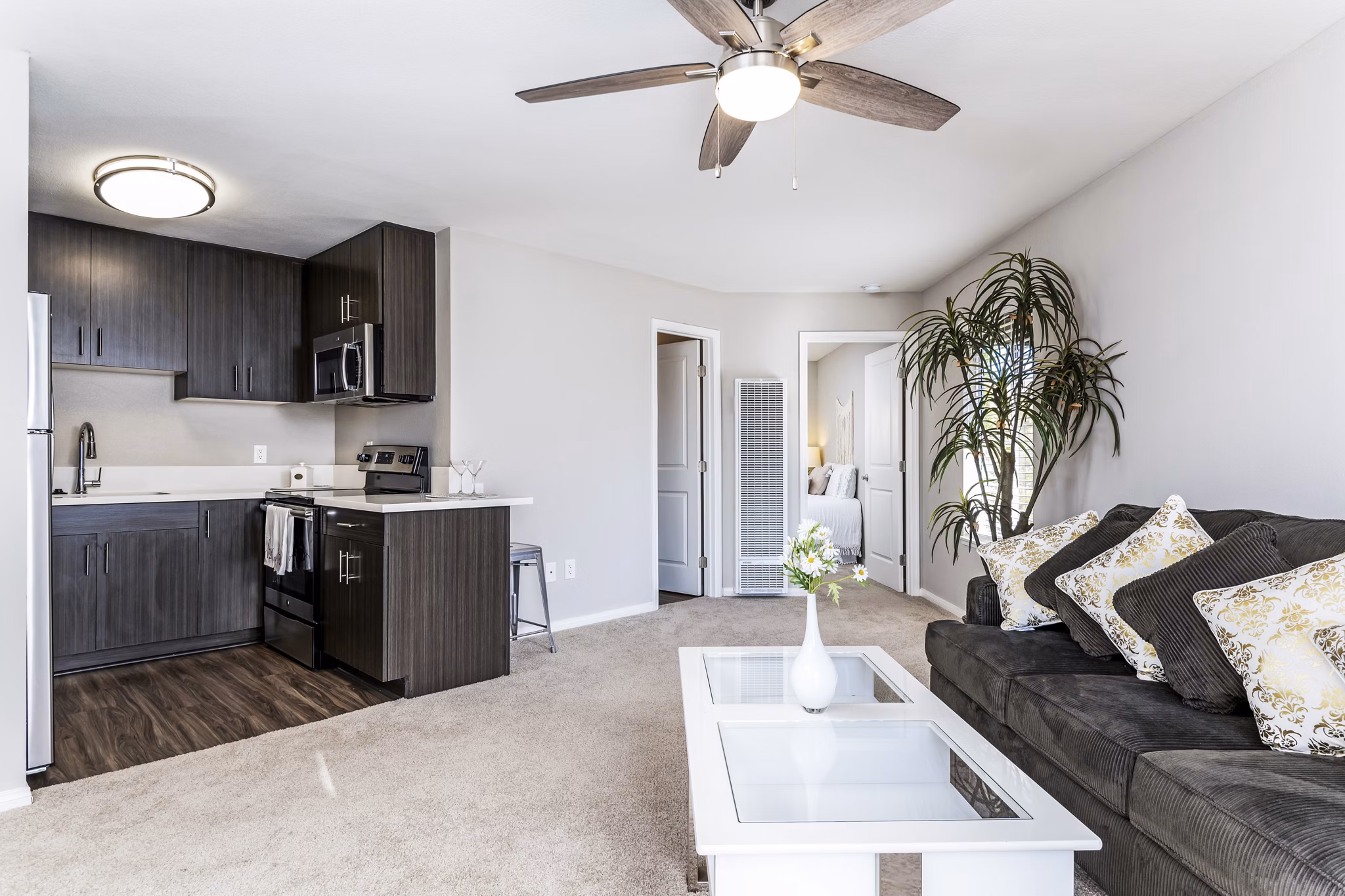 Spacious living room with modern decor at Village Square Apartments, offering luxury living in a premier location