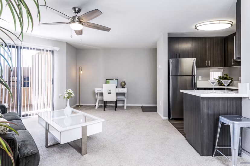 Living room with cozy seating and modern decor in Village Square Apartments