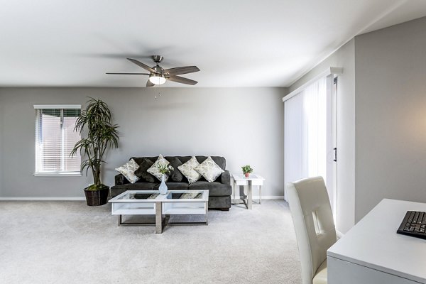 Elegant living room with modern decor and natural light at Village Square Apartments