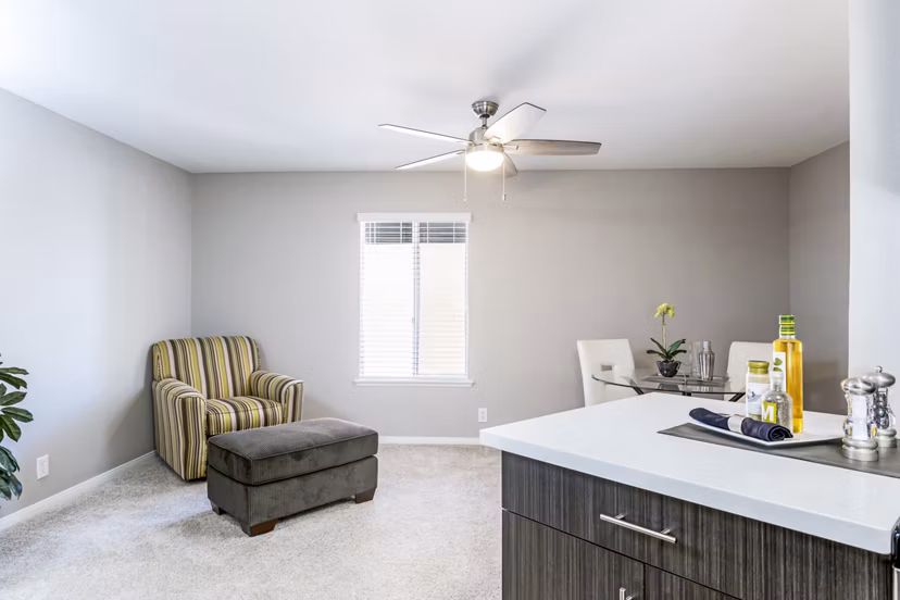 Modern living room with large sofa and wall art in Village Square Apartments
