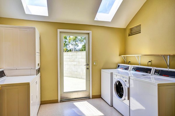 Laundry facility featuring modern machines at Village Square Apartments