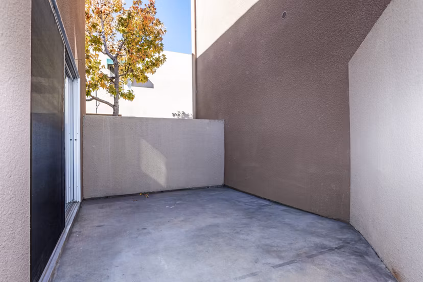 Patio with outdoor seating at Village Square Apartments, ideal for relaxation and social gatherings