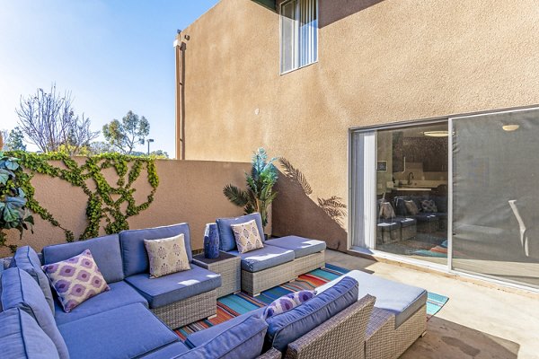 Village Square Apartments: Cozy patio with outdoor seating and green views