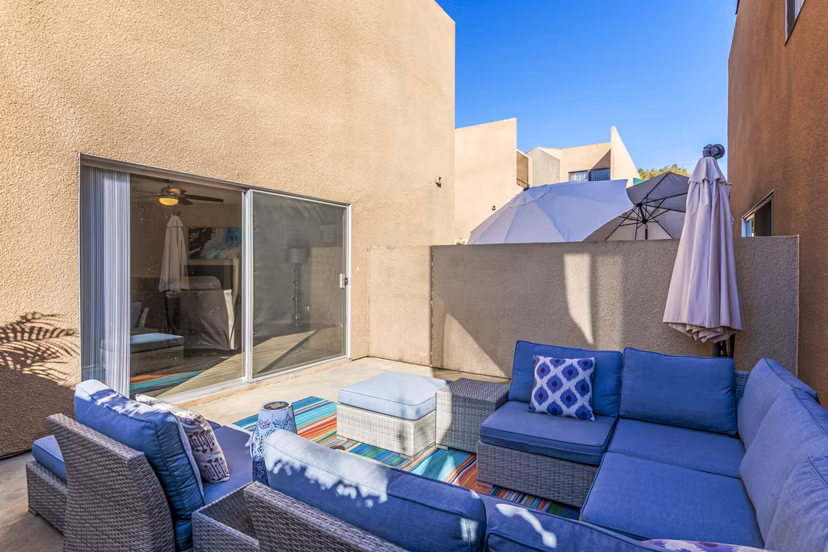 Cozy patio with outdoor seating at Village Square Apartments, perfect for relaxing and enjoying views of the surroundings