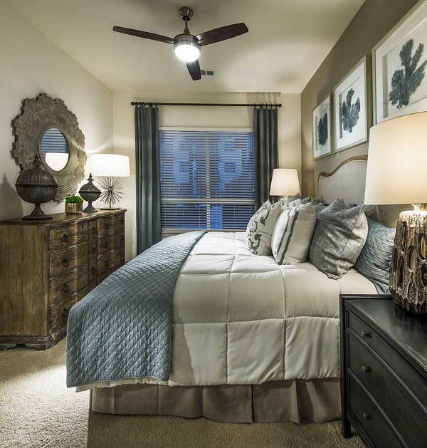 Cozy bedroom with large window and modern decor in Vora Mission Valley West Apartments