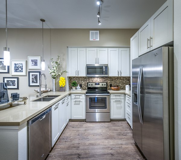 Sleek kitchen with stainless steel appliances at Vora Mission Valley West Apartments, perfect for modern living
