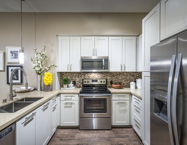 Modern kitchen with stainless steel appliances at Vora Mission Valley West Apartments