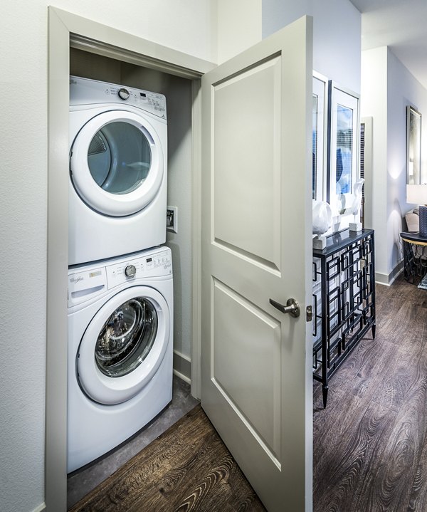Modern laundry room with high-efficiency washers and dryers at Vora Mission Valley West Apartments