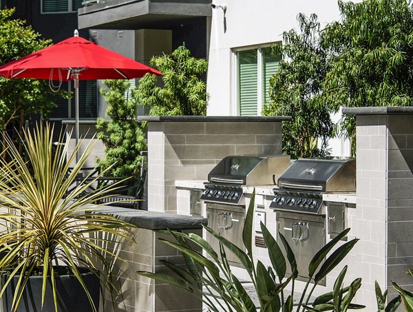 Outdoor grill area with modern seating at Vora Mission Valley West Apartments, perfect for entertaining in San Diego's premier community