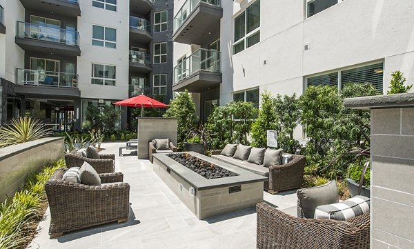 Fire pit lounge area at Vora Mission Valley West Apartments offering a cozy outdoor seating experience