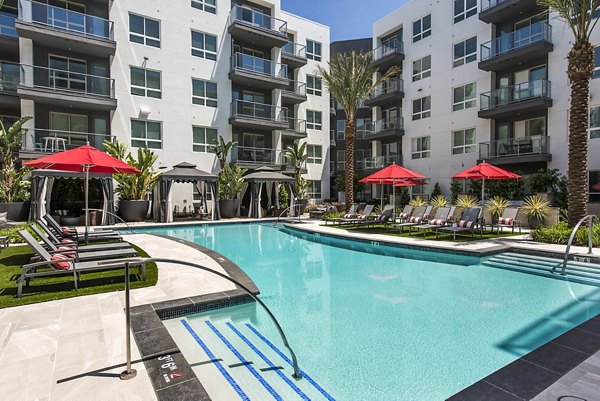 Infinity-edge pool at Vora Mission Valley West Apartments with palm tree surroundings, offering a luxury retreat experience